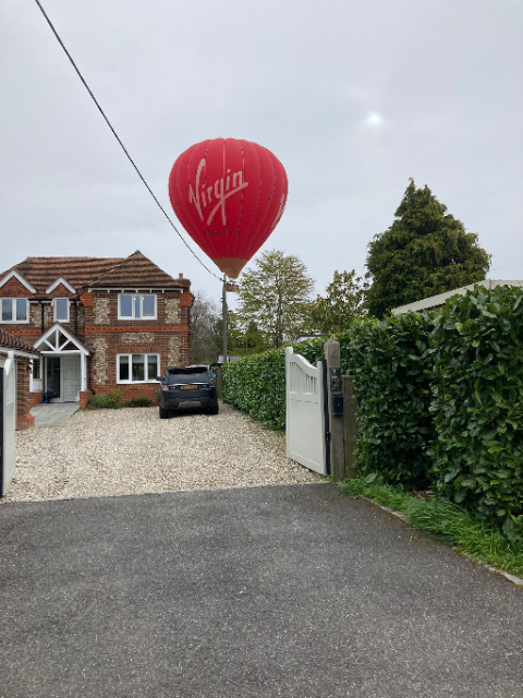 Red hot air balloon above Longmoor Lane